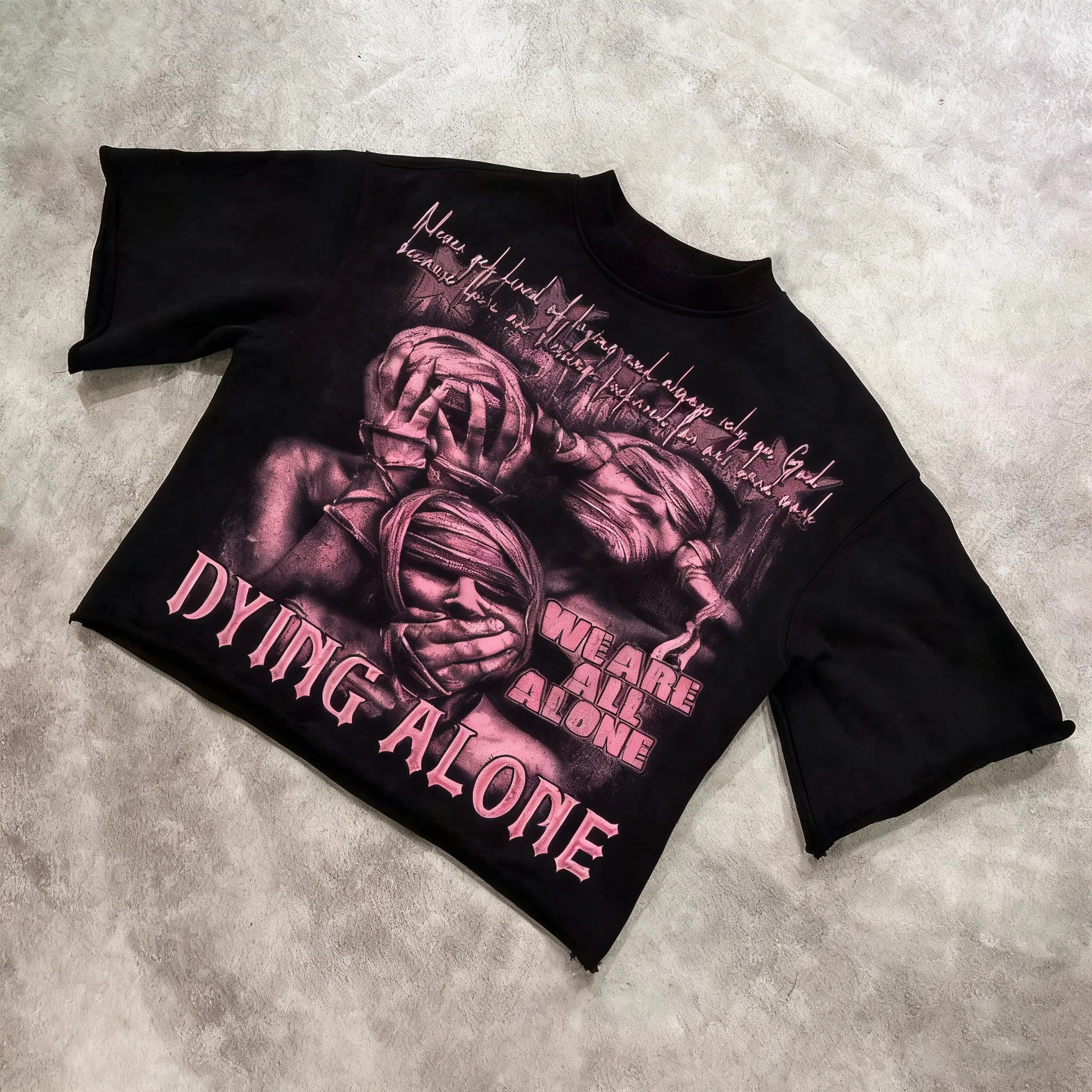 Black t-shirt with graphic design and text on a textured surface